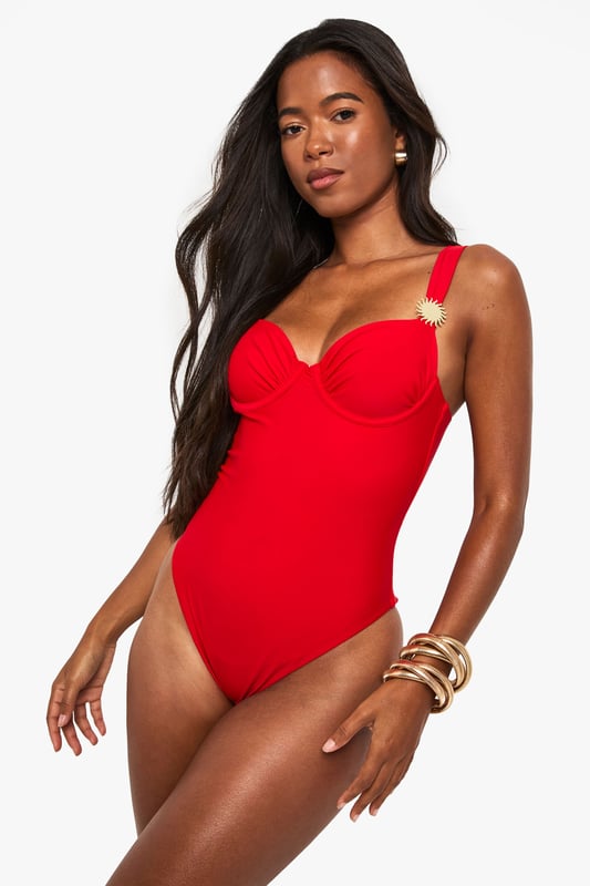 Striking balconette design with structured cups for enhanced shape and support
        Elegant sunshine detail on strap adds a distinctive touch to this swimwear piece
        Flattering high-cut leg line elongates the silhouette
        Adjustable shoulder straps for a customised fit
        Sleek, streamlined design with a smooth finish for a confident poolside look
    
    Make a statement by the pool or on the beach with this eye-catching balconette swimsuit. The structured cups create a flattering silhouette whilst providing excellent support for all-day comfort. The distinctive sunshine detail adds a playful yet sophisticated touch that catches the light beautifully as you lounge by the water. Style with oversized sunglasses and a wide-brimmed hat for ultimate holiday glamour, or layer under a sheer kaftan for elegant poolside drinks. Perfect for everything from active swimming to leisurely sunbathing, this versatile swimsuit transitions effortlessly from day to evening with the addition of a flowing maxi skirt and statement jewellery. The timeless design ensures this piece will remain a holiday favourite for seasons to come.