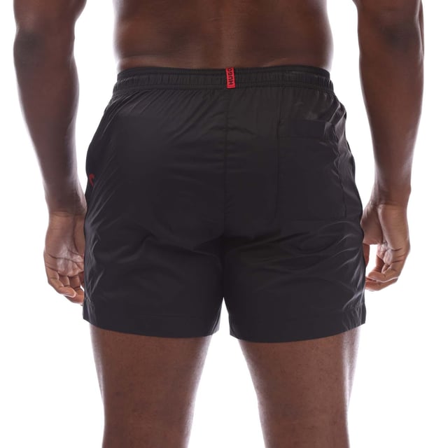 Mens Hugo Fab Logo Tape Swim Shorts in black.- Elasticated waistband.- Side pockets.- Patch pocket.- Trimmed with logo tape on the side seams.- Regular fit.- 100% Polyamide.- Ref: 50500973001