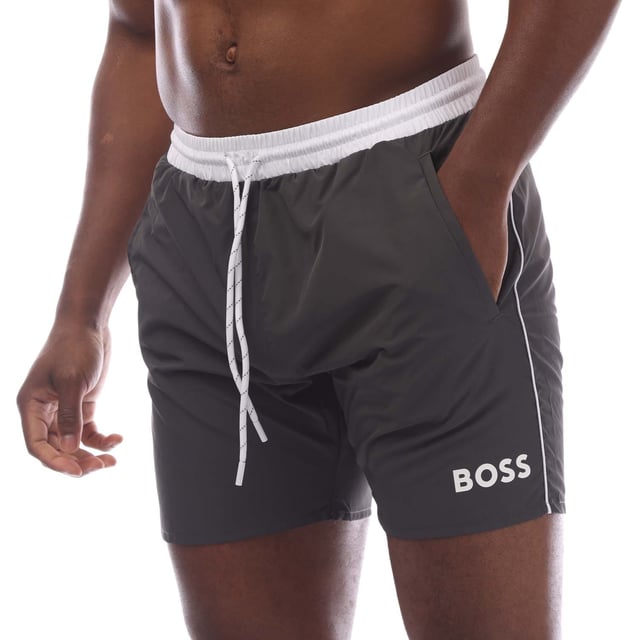 Mens Hugo Starfish Swim Shorts in charcoal.- Elasticated drawstring waist.- Side pockets.- Back pocket.- Boss branding on the leg.- Mesh polyester lining enhances breathability and comfort for a seamless swimming experience.- 100% Polyester (Recycled).- Ref: 50515191011