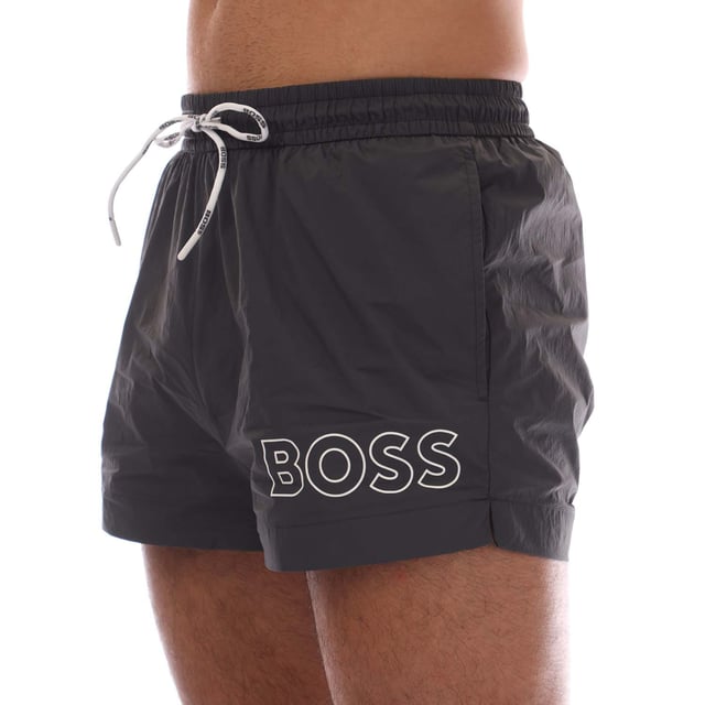 Mens Hugo Boss Mooneye Swim Shorts in charcoal.- Elastic waistband.- Side pockets.- Short length.- Plastic-tipped drawcords with further branding complete this pair.- Printed with a large BOSS logo.- 100% Polyamide.- Ref: 50469280011