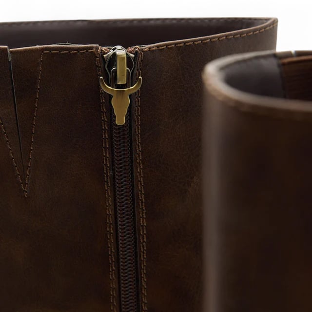 Elevate your look with the Windsor Smith Niche knee high platform boots. Designed with a sleek non-leather upper and lining, these knee-high boots combine bold style with comfort and functionality. The 90 mm block heel and 35 mm platform provide height and stability, while the soft square toe adds a modern touch. A full-length inside zipper with a signature bull zip puller makes for easy wear. Finished with a durable rubber outsole and leather-covered platform heels, these boots are perfect for statement-making style.

Upper: Faux Leather
Lining: Synthetic
Sole: Rubber
Height: Knee-High
Heel Height: 90 mm (9 cm)
Platform Height: 35 mm (3.5 cm)
Closure: Full-length inside zipper with bull puller
Toe: Soft Square
Heel Type: Block heel
Details: Leather-covered platform heels