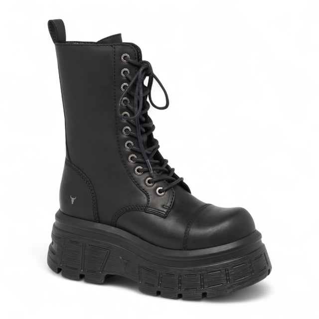 Make a fearless statement with the Windsor Smith Screaming platform boots - where combat style meets elevated edge. Crafted from cow waxy leather, these 11-eyelet lace-up boots feature a chunky cleated platform wedge sole, reinforced toe cap, and heavy cable stitch detail. The inside zip allows for easy slip-on access, while the leather pull tab and embossed bull logo at the back add signature Windsor Smith touches. Designed for attitude and comfort, they stand tall with a 7.5 cm heel and 5.6 cm platform.
Upper: Cow Waxy Leather
Lining: Non-Leather
Sole: Lightweight PU (cleated wedge)
Closure: Lace-up with inside zip
Toe: Round with toe cap
Platform Height: 5.6 cm
Heel Height: 7.5 cm
Design: Chunky combat boot with heavy stitch detail
Branding: Embossed bull logo at back