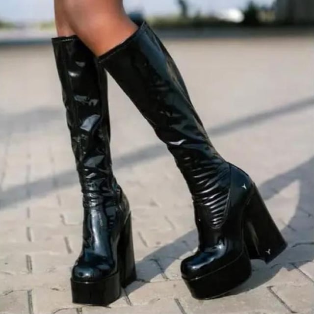 Own the spotlight in the Windsor Smith Saucy black stretch platform boots. These striking knee-high sock boots feature a sleek, non-leather upper that hugs the leg for a bold, sculpted silhouette. Set on towering 15.2 cm chunky block heels with a 5.7 cm platform, they offer dramatic height without compromising stability. Complete with Windsor Smith's iconic bullhead logo on the heel and sole, these boots are designed to turn heads and elevate your wardrobe.

Upper: Black Stretch (Non-Leather)
Lining: Non-Leather
Sole: Non-Leather
Style: Knee-high sock boots
Heel Height: 15.2 cm
Platform Height: 5.7 cm
Design: Chunky platform block heel