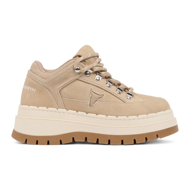 Meet the Windsor Smith Ultimatum - Women’s platform sneakers redefined with a rugged twist. Crafted with a soft sand suede upper and contrast stitching, these chunky sneakers feature a two-tone TPR platform sole that combines street style with hiking influence. Metal hook-and-eye details and bull-logo silver D-rings elevate the design, while the twin-colored laces, padded tongue, and collar offer added comfort. With a 63 mm heel and a 46 mm forepart platform, these cross-hiker sneakers deliver elevated style without compromising stability.

Upper: Sand Suede
Lining: Sports Fabric
Sole: Two-tone Chunky TPR
Closure: Twin-colored lace with metal hook & eye + D-rings
Heel Height: 63 mm
Platform Forepart Height: 46 mm
Design: Cross between hiker boot and sneaker
Details: Padded tongue and collar, contrast stitching, molded footbed