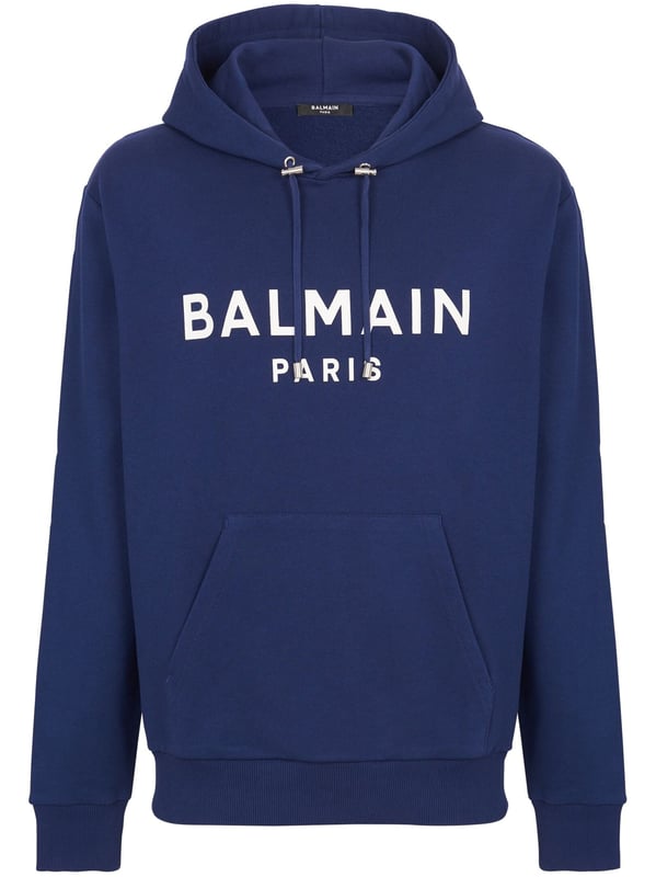 Balmain's Paris hoodie is a stylish hooded sweatshirt with a straight cut design. It features ribbed detailing and an adjustable drawstring neckline for a comfortable fit. The long sleeves and kangaroo pocket add a practical touch, while the chest logo adds a subtle branding element. Perfect for casual, everyday wear.