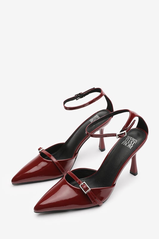 Wheres That From Womens 'Katherine' Strappy Pointed Toe High Heels Make a bold entrance with these Katherine Strappy Pointed Toe High Heels, crafted for standout sophistication. Featuring a pointed toe, slim stiletto heel, and delicate buckle straps, they bring timeless elegance with a modern twist. The glossy finish adds a luxurious edge, perfect for evening events, date nights, or dressing up denim. Key Features: • Material: High-shine patent faux leather upper • Design: Pointed toe with dual buckle strap and stiletto heel • Closure: Adjustable ankle and front buckle straps