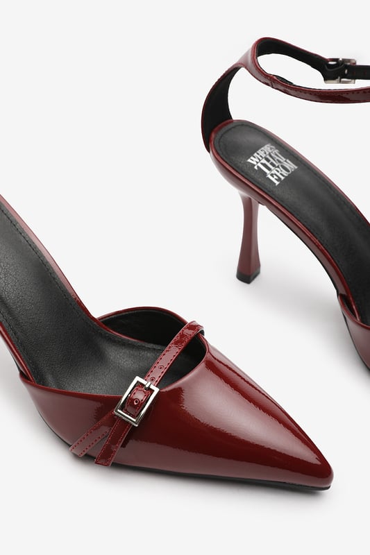 Wheres That From Womens 'Katherine' Strappy Pointed Toe High Heels Make a bold entrance with these Katherine Strappy Pointed Toe High Heels, crafted for standout sophistication. Featuring a pointed toe, slim stiletto heel, and delicate buckle straps, they bring timeless elegance with a modern twist. The glossy finish adds a luxurious edge, perfect for evening events, date nights, or dressing up denim. Key Features: • Material: High-shine patent faux leather upper • Design: Pointed toe with dual buckle strap and stiletto heel • Closure: Adjustable ankle and front buckle straps