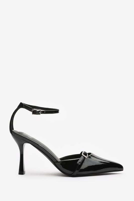 Wheres That From Womens 'Katherine' Strappy Pointed Toe High Heels Make a bold entrance with these Katherine Strappy Pointed Toe High Heels, crafted for standout sophistication. Featuring a pointed toe, slim stiletto heel, and delicate buckle straps, they bring timeless elegance with a modern twist. The glossy finish adds a luxurious edge, perfect for evening events, date nights, or dressing up denim. Key Features: • Material: High-shine patent faux leather upper • Design: Pointed toe with dual buckle strap and stiletto heel • Closure: Adjustable ankle and front buckle straps