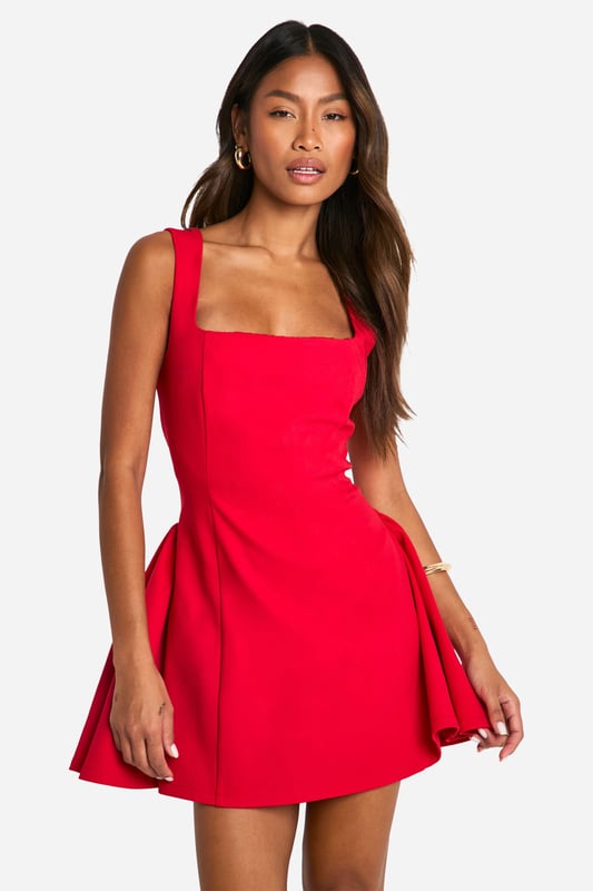 Striking square neckline for a modern twist
        Sleeveless design with wide straps for a flattering silhouette
        Figure-hugging bodice that flares into a playful skirt
        Mini length perfect for showcasing legs
        Versatile style suitable for various evening occasions
    
    Make a bold statement with this eye-catching mini dress that's designed to turn heads. The square neckline adds a contemporary edge, while the sleeveless cut and wide straps create a balanced and flattering upper body shape. The dress's silhouette is expertly crafted to hug your curves before gracefully flaring out into a flirty skirt, offering both comfort and style. Perfect for a night out on the town, this dress pairs beautifully with strappy heels and statement earrings for a look that's sure to impress. Whether you're dancing the night away at a club or enjoying cocktails at a trendy bar, this versatile piece will keep you looking chic and feeling confident. For a more relaxed vibe, throw on a leather jacket and ankle boots to effortlessly transition from day to night.