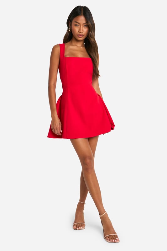 Striking square neckline for a modern twist
        Sleeveless design with wide straps for a flattering silhouette
        Figure-hugging bodice that flares into a playful skirt
        Mini length perfect for showcasing legs
        Versatile style suitable for various evening occasions
    
    Make a bold statement with this eye-catching mini dress that's designed to turn heads. The square neckline adds a contemporary edge, while the sleeveless cut and wide straps create a balanced and flattering upper body shape. The dress's silhouette is expertly crafted to hug your curves before gracefully flaring out into a flirty skirt, offering both comfort and style. Perfect for a night out on the town, this dress pairs beautifully with strappy heels and statement earrings for a look that's sure to impress. Whether you're dancing the night away at a club or enjoying cocktails at a trendy bar, this versatile piece will keep you looking chic and feeling confident. For a more relaxed vibe, throw on a leather jacket and ankle boots to effortlessly transition from day to night.