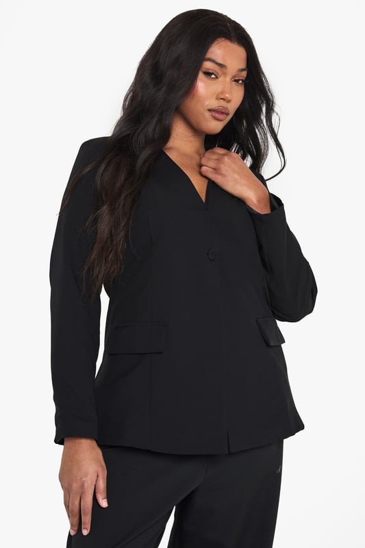 Striking plunge neckline for a bold, contemporary silhouette
        Structured shoulders create a flattering, defined shape
        Practical front pockets add functionality to this stylish piece
        Long sleeves with clean-cut finish for a sophisticated look
        Versatile design perfect for transitioning from day to night
    
    Make a statement with this curve-enhancing blazer featuring a daring plunge neckline that commands attention. The tailored fit creates a sleek silhouette whilst the structured design offers a contemporary twist on classic tailoring. Style with the matching wide-leg trousers as seen on our model for a coordinated evening ensemble, or pair with your favourite jeans and heels for drinks with the girls. For club nights, accessorise with statement earrings and a clutch bag to showcase the blazer's dramatic neckline. This versatile piece works brilliantly for urban nightlife settings where you want to project confidence and style without compromising on comfort. The clean lines and unfussy detailing ensure this blazer remains a wardrobe staple that you'll reach for time and again when planning your going-out looks.