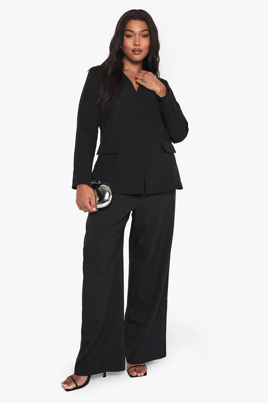 Striking plunge neckline for a bold, contemporary silhouette
        Structured shoulders create a flattering, defined shape
        Practical front pockets add functionality to this stylish piece
        Long sleeves with clean-cut finish for a sophisticated look
        Versatile design perfect for transitioning from day to night
    
    Make a statement with this curve-enhancing blazer featuring a daring plunge neckline that commands attention. The tailored fit creates a sleek silhouette whilst the structured design offers a contemporary twist on classic tailoring. Style with the matching wide-leg trousers as seen on our model for a coordinated evening ensemble, or pair with your favourite jeans and heels for drinks with the girls. For club nights, accessorise with statement earrings and a clutch bag to showcase the blazer's dramatic neckline. This versatile piece works brilliantly for urban nightlife settings where you want to project confidence and style without compromising on comfort. The clean lines and unfussy detailing ensure this blazer remains a wardrobe staple that you'll reach for time and again when planning your going-out looks.