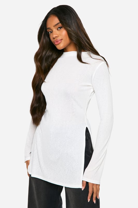 Transparent maxi top for a daring look
        Elegant turtleneck design adds sophistication
        Long sleeves for versatile styling options
        Side slits enhance movement and comfort
        Fitted silhouette accentuates your curves
    
    Make a bold statement with this transparent maxi top, perfect for the fashion-forward woman who loves to push boundaries. The turtleneck design adds a touch of elegance, while the long sleeves offer versatility for various occasions. Style it over a sleek bodysuit or bralette for a night out, or layer it over a cami for a more subdued daytime look. The side slits not only provide ease of movement but also create an alluring silhouette. Pair with wide-leg trousers and strappy heels for a chic ensemble, or dress it down with your favourite jeans and trainers for a casual yet trendy outfit. This top is ideal for those who want to make an impression at social gatherings, brunches with friends, or even as a unique layering piece for festival season. Its versatility allows you to customise your look, making it a must-have addition to any fashion-savvy wardrobe.