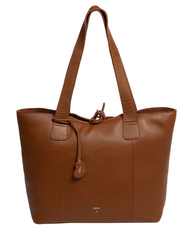 Handcrafted from natural leather with a soft to the touch pebble grain finish, the 'Carolina' tote bag from NiNa Amora is a must-have accessory. A unique tie top secures the central lined compartment which includes a zipped compartment which divides the design; perfect for maintaining an organised bag. Additional storage space is provided by a slip and zipped pocket on the interior, ideal for your phone, keys and any other essentials while out and about. Adorned with dual leather handles with a drop length of 25cm for a comfortable and versatile carrying options. Silver metal fittings and zips give this design a elegant look which is complemented the NiNa Amora X logo is silver foil embossed on the front and hanging charm for a luxurious finishing touch.