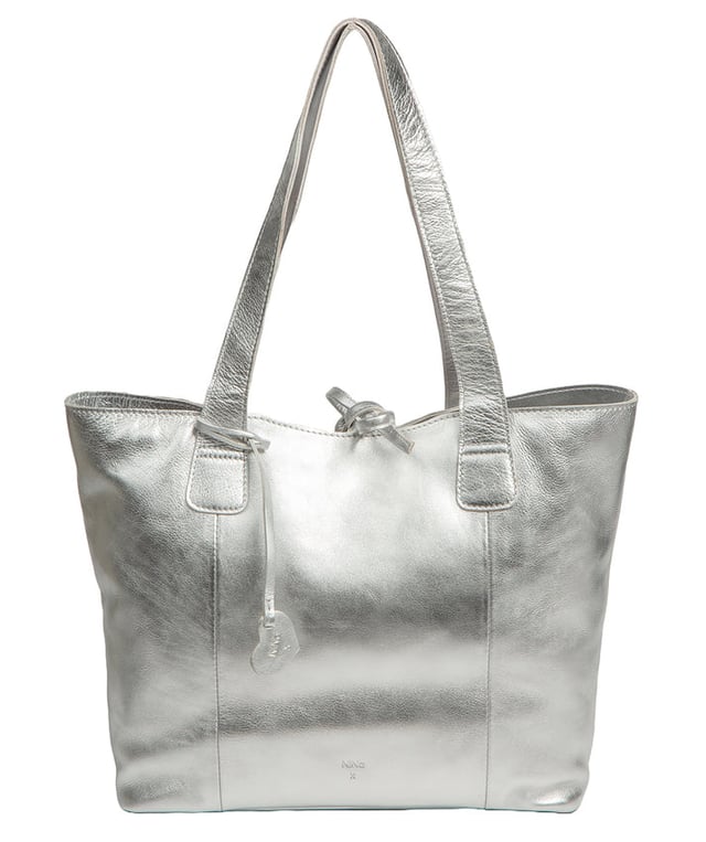 Handcrafted from natural leather with a soft to the touch pebble grain finish, the 'Carolina' tote bag from NiNa Amora is a must-have accessory. A unique tie top secures the central lined compartment which includes a zipped compartment which divides the design; perfect for maintaining an organised bag. Additional storage space is provided by a slip and zipped pocket on the interior, ideal for your phone, keys and any other essentials while out and about. Adorned with dual leather handles with a drop length of 25cm for a comfortable and versatile carrying options. Silver metal fittings and zips give this design a elegant look which is complemented the NiNa Amora X logo is silver foil embossed on the front and hanging charm for a luxurious finishing touch.