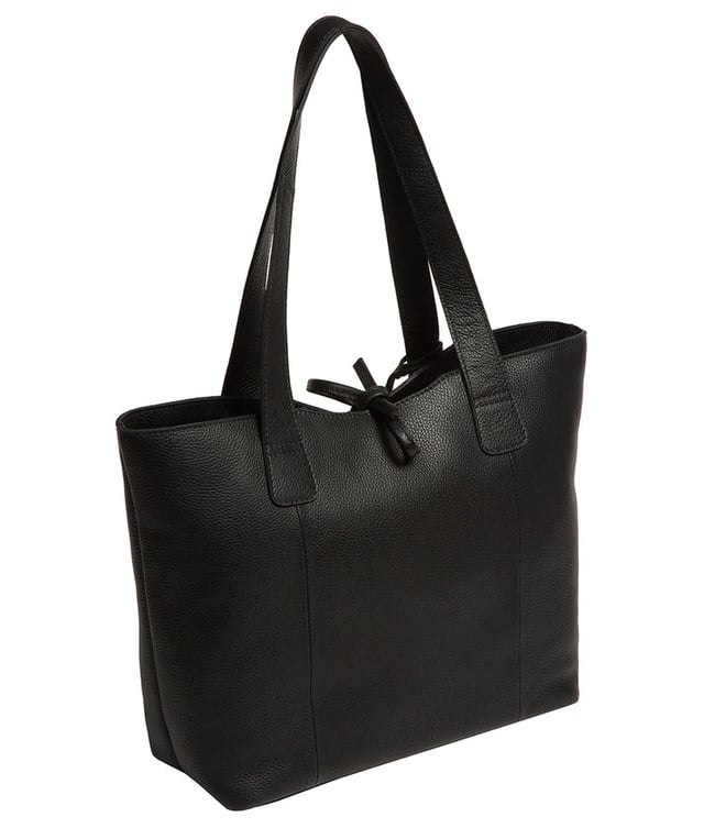 Handcrafted from natural leather with a soft to the touch pebble grain finish, the 'Carolina' tote bag from NiNa Amora is a must-have accessory. A unique tie top secures the central lined compartment which includes a zipped compartment which divides the design; perfect for maintaining an organised bag. Additional storage space is provided by a slip and zipped pocket on the interior, ideal for your phone, keys and any other essentials while out and about. Adorned with dual leather handles with a drop length of 25cm for a comfortable and versatile carrying options. Silver metal fittings and zips give this design a elegant look which is complemented the NiNa Amora X logo is silver foil embossed on the front and hanging charm for a luxurious finishing touch.