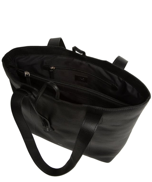 Handcrafted from natural leather with a soft to the touch pebble grain finish, the 'Carolina' tote bag from NiNa Amora is a must-have accessory. A unique tie top secures the central lined compartment which includes a zipped compartment which divides the design; perfect for maintaining an organised bag. Additional storage space is provided by a slip and zipped pocket on the interior, ideal for your phone, keys and any other essentials while out and about. Adorned with dual leather handles with a drop length of 25cm for a comfortable and versatile carrying options. Silver metal fittings and zips give this design a elegant look which is complemented the NiNa Amora X logo is silver foil embossed on the front and hanging charm for a luxurious finishing touch.