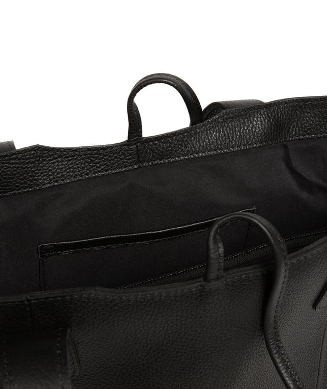 Handcrafted from natural leather with a soft to the touch pebble grain finish, the 'Carolina' tote bag from NiNa Amora is a must-have accessory. A unique tie top secures the central lined compartment which includes a zipped compartment which divides the design; perfect for maintaining an organised bag. Additional storage space is provided by a slip and zipped pocket on the interior, ideal for your phone, keys and any other essentials while out and about. Adorned with dual leather handles with a drop length of 25cm for a comfortable and versatile carrying options. Silver metal fittings and zips give this design a elegant look which is complemented the NiNa Amora X logo is silver foil embossed on the front and hanging charm for a luxurious finishing touch.