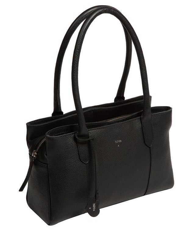 The 'Beatriz' handbag from NiNa Amora is crafted from natural leather with a soft to the touch pebble grain finish. This classic design is elevated thanks to the unique trio of main compartments. This comes in the form of a zipped central section with two magnetic press stud fastened slip pockets on either side; perfect for maintaining an organised accessory. Additional storage space is provided by slip pockets on the interior and exterior alongside a zipped pocket which lines the interior. Dual rounded leather handles adorn the bag with a drop length of 20cm. Silver coloured metal fittings and zips give this design a elegant look which pops against the leather exterior and complemented the NiNa Amora X logo which is silver foil embossed on the front and hanging charm for a luxurious finishing touch.