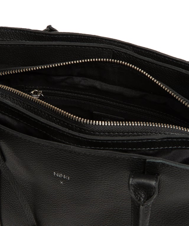 The 'Beatriz' handbag from NiNa Amora is crafted from natural leather with a soft to the touch pebble grain finish. This classic design is elevated thanks to the unique trio of main compartments. This comes in the form of a zipped central section with two magnetic press stud fastened slip pockets on either side; perfect for maintaining an organised accessory. Additional storage space is provided by slip pockets on the interior and exterior alongside a zipped pocket which lines the interior. Dual rounded leather handles adorn the bag with a drop length of 20cm. Silver coloured metal fittings and zips give this design a elegant look which pops against the leather exterior and complemented the NiNa Amora X logo which is silver foil embossed on the front and hanging charm for a luxurious finishing touch.