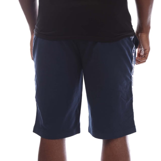 Mens DKNY Sea Dogs Lounge Shorts in navy.- Elasticated waistband with drawstring fastening.- Two handy side pockets.- DKNY branding down the leg.- Spun in soft jersey fabric.- 100% Cotton.- Ref: N56804DKYNV