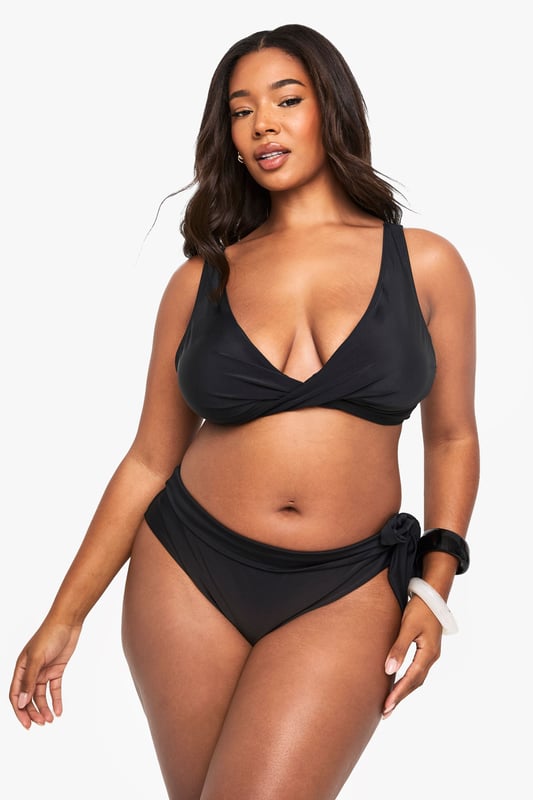 Stylish lace-up detail on the sides for an adjustable fit
        Mid-rise design offering comfortable coverage
        Side tie feature that can be styled in multiple ways
        Smooth fabric with excellent stretch for all-day comfort
        Designed specifically for curvy figures in our inclusive plus size range
    
    Make waves this season with our plus size lace-up bikini bottoms from Boohoo. These versatile bottoms feature an eye-catching side tie detail that allows you to customise your look and adjust for the perfect fit. The mid-rise design offers just the right amount of coverage whilst maintaining a fashion-forward silhouette. Pair with the matching bikini top as shown for a coordinated beach look, or mix with other tops in your collection for a personalised style statement. Perfect for your next holiday, lounging by the pool or soaking up the sun at the beach. The stretchy fabric moves with your body for lasting comfort throughout the day, whilst the classic design ensures these bottoms will remain a staple in your swimwear collection for seasons to come.