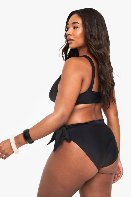 Stylish lace-up detail on the sides for an adjustable fit
        Mid-rise design offering comfortable coverage
        Side tie feature that can be styled in multiple ways
        Smooth fabric with excellent stretch for all-day comfort
        Designed specifically for curvy figures in our inclusive plus size range
    
    Make waves this season with our plus size lace-up bikini bottoms from Boohoo. These versatile bottoms feature an eye-catching side tie detail that allows you to customise your look and adjust for the perfect fit. The mid-rise design offers just the right amount of coverage whilst maintaining a fashion-forward silhouette. Pair with the matching bikini top as shown for a coordinated beach look, or mix with other tops in your collection for a personalised style statement. Perfect for your next holiday, lounging by the pool or soaking up the sun at the beach. The stretchy fabric moves with your body for lasting comfort throughout the day, whilst the classic design ensures these bottoms will remain a staple in your swimwear collection for seasons to come.