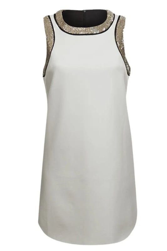 A dress to party in, all summer. Made in a white bonded scuba fabric with gold sequin and black edge trim, back zip up, feature curved hemline
Sequin Trim Neoprene 
94% Polyester, 6% Elastane
Sizing is as expected
Length: 32" Shoulder to Hem
Rounded neckline
Sleeveless
Back zip fastening
Feature curved hemline.