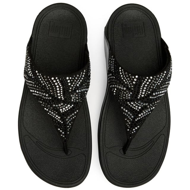 Sandalias Fitflop Lulu Cristal Pluma Estas no son tus sandalias promedio. La Lulu Crystal Feather eleva la comodidad casual con detalles de cristal que brillan y capturan la luz maravillosamente. Construidas sobre la suela micro wobbleboard característica de FitFlop, ofrecen soporte ergonómico mientras que el tacón de 4 cm añade un sutil aumento de altura. Las elegantes correas sintéticas negras ofrecen durabilidad y estilo que se adaptan sin esfuerzo desde la piscina hasta paseos nocturnos.
