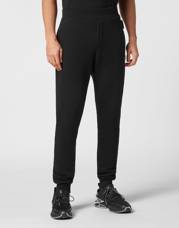 These joggers are the perfect match to achieve your goals. Comfort and performance add up to the style of Plein Sport.   Cotton fleece   Rubberized Tiger patch sewn on the left leg   Patches with lettering sewn on the back of left leg   Elasticated waistband    Two slit pockets   Loose fit for greater comfort   Rib knit bottom cuffs