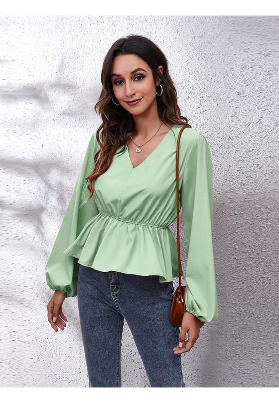 Basic style
  Opaque fabric
  No stretch
  100% polyester
  Machine wash cold
  Tumble dry low
  Imported
  Product measurements:
  S: bust 38.2 in shoulder 14.4 in sleeve length 25 in length 21.5 in
  M: bust 39.8 in shoulder 14.8 in sleeve length 25.4 in length 21.8 in
  L: bust 42.1 in shoulder 15.2 in sleeve length 25.7 in length 22.2 in
  XL: bust 44.5 in shoulder 15.6 in sleeve length 26.1 in length 22.6 in
Material: The material appears to be a lightweight possibly cotton or polyester blend giving it a smooth texture.  The design includes a peplum waistline and long balloon sleeves.