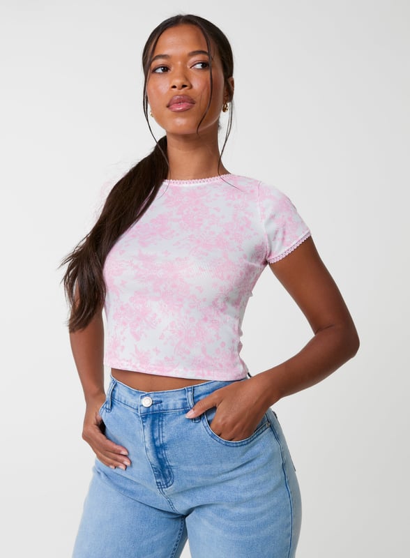 Step into the new season with this must-have floral print crop top. Style it with jorts and sandals for an elevated summer look you'll love.