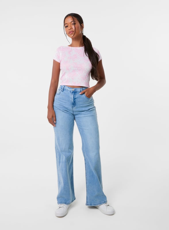 Step into the new season with this must-have floral print crop top. Style it with jorts and sandals for an elevated summer look you'll love.