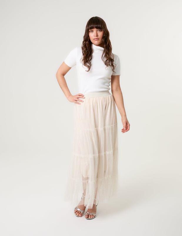 Elevate your wardrobe and feel fabulous in this statement layering tulle skirt. With its elasticated waistband for a comfortable fit, team this skirt with a basic oversized tee and pumps, for a chic kinda look.     