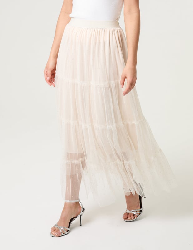 Elevate your wardrobe and feel fabulous in this statement layering tulle skirt. With its elasticated waistband for a comfortable fit, team this skirt with a basic oversized tee and pumps, for a chic kinda look.     