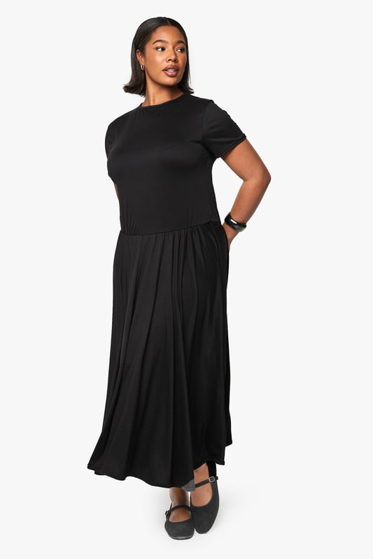 Relaxed T-shirt style bodice with classic crew neckline for everyday comfort
        Flowing maxi-length skirt with generous volume for graceful movement
        Short sleeves with neat finish for a clean, contemporary silhouette
        Soft viscose fabric drapes beautifully around the figure
        Versatile drop-waist design creates an effortlessly chic look
    
    This T-shirt-style maxi dress combines comfort with understated sophistication. The relaxed bodice transitions into a voluminous skirt that creates a flattering silhouette for all body types. Style with flat ballet pumps and a structured handbag as shown for daytime outings, or transform your look with chunky trainers and a denim jacket for casual weekend brunches. For evening gatherings, add statement jewellery and a leather jacket for an edgy contrast to the dress's flowing lines. The simple design makes this piece perfect for layering during cooler months - try with a longline cardigan and ankle boots. This wardrobe essential works beautifully for family gatherings, casual office days, or weekend city breaks where versatility is key.