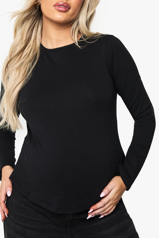 Long-sleeved maternity T-shirt with distinctive split hem design for growing bump accommodation
        Soft cotton fabric provides all-day comfort throughout your pregnancy journey
        Classic crew neckline offers versatile styling options for layering or wearing alone
        Thoughtfully tailored silhouette that grows with you while maintaining a flattering shape
        Curved split hem detail adds contemporary flair to this essential maternity staple
    
    This essential maternity long-sleeved T-shirt combines practicality with style for the fashion-forward mum-to-be. The clever split hem design allows room for your growing bump whilst maintaining a sleek silhouette. Style with wide-leg black denim and trainers for casual weekend brunches, or layer under a chunky cardigan with leggings for relaxed family gatherings. The versatile crew neck makes it perfect for accessorising - add a statement necklace or patterned scarf to refresh your look. For a trendy daytime outfit, pair with an animal print bag as shown for added visual interest. This adaptable cotton top will become your go-to throughout pregnancy, offering comfort without compromising on style - the ultimate wardrobe essential that works across all three trimesters.