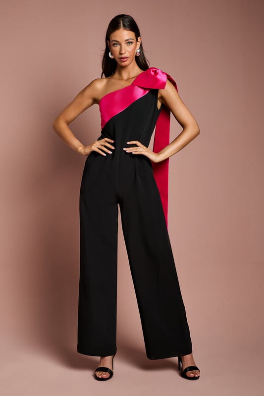 Bow One Shoulder Jumpsuit One-shoulder design with a dramatic bow detail
Wide-leg jumpsuit silhouette with a flattering waist tie
crepe fabric with a luxurious drape
Sleeveless bodice with a fitted waist
Full-length wide legs for an elegant, flowing look
Exuding sophistication and glamour, this jumpsuit is a showstopping choice for formal occasions. The one-shoulder neckline with a striking bow detail adds a touch of drama, while the crepe fabric drapes beautifully for a refined look. Style it with statement jewellery and heels for a wedding or evening event, or pair it with a fascinator and clutch for a day at the races. With its flattering waist tie and flowing wide legs, this jumpsuit is sure to turn heads and make a lasting impression.