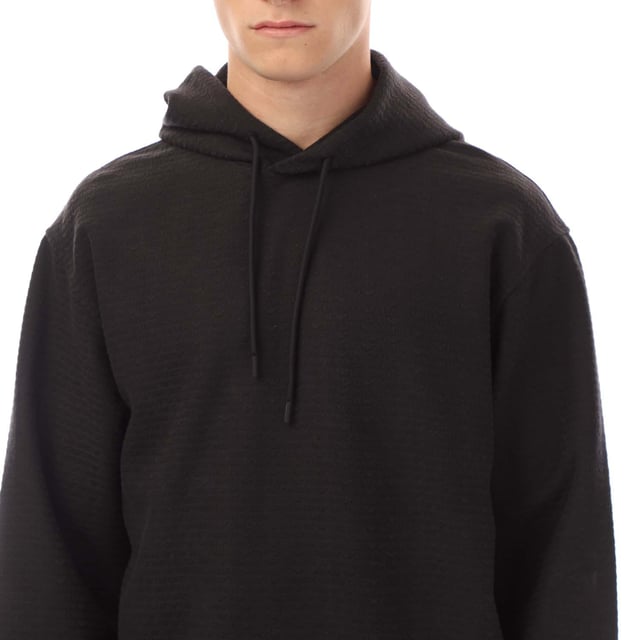 Mens Emporio Armani Allover Lettering Hoodie in black.- Drawstring hood.- Jacquard.- All-over flock print.- Regular fit.- 46% Cotton  46% Lyocell  8% Elastane.- Ref: EM001007AUC001