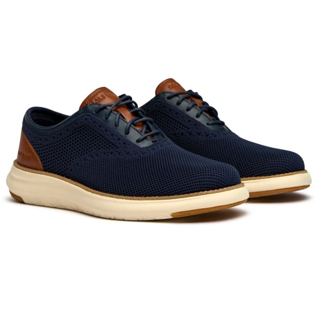 These aren't your typical dress shoes. The Cole Haan Grand Remix Knit combines breathable textile construction with sophisticated leather accents, creating a modern hybrid that works from boardroom to weekend. The innovative FlowerFoam sole delivers exceptional comfort and energy return, while the lightweight design keeps you moving effortlessly through long days. Blue never looked so versatile.