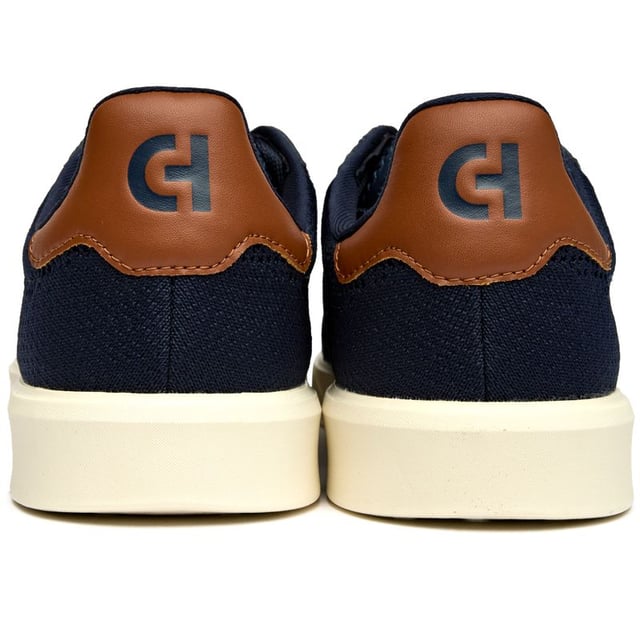 The Cole Haan Grand Court Daily Stitch brings athletic sophistication to your everyday rotation. Crafted with a breathable stitchlite upper in rich blue, these court-inspired trainers blend premium textile construction with serious comfort credentials. The padded collar and plush insole ensure all-day wearability, while the lightweight rubber sole delivers reliable traction whether you're courtside or city-bound. Modern comfort meets timeless style.
