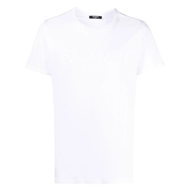 Balmain Paris Embossed Logo White T-shirt Elevate your wardrobe with the Balmain Paris Embossed Logo White T-Shirt, crafted from 100% premium cotton for exceptional comfort and breathability. Made in Portugal, this sleek white tee features a subtle yet striking embossed Balmain Paris logo, adding a touch of luxury to your everyday style. Its high-quality fabric ensures durability while maintaining a soft feel against the skin. Perfect for pairing with jeans or layering under jackets, this versatile t-shirt combines timeless design with modern sophistication, making it an essential piece for any fashion-conscious man. Experience effortless elegance with Balmain
