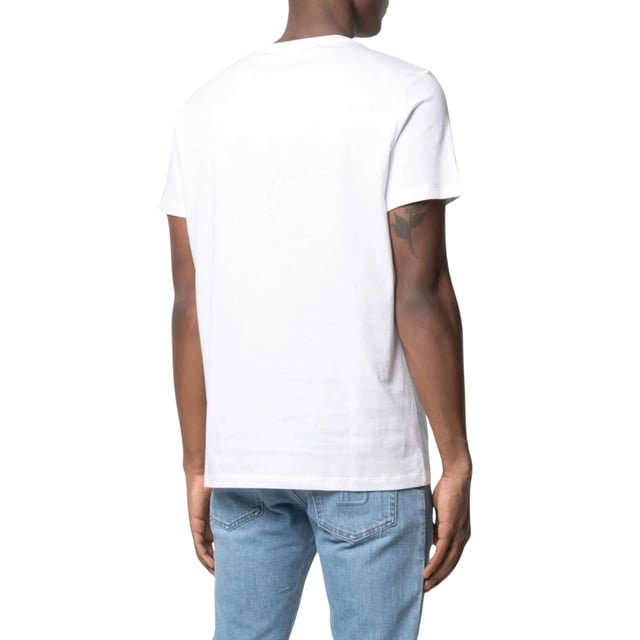 Balmain Paris Embossed Logo White T-shirt Elevate your wardrobe with the Balmain Paris Embossed Logo White T-Shirt, crafted from 100% premium cotton for exceptional comfort and breathability. Made in Portugal, this sleek white tee features a subtle yet striking embossed Balmain Paris logo, adding a touch of luxury to your everyday style. Its high-quality fabric ensures durability while maintaining a soft feel against the skin. Perfect for pairing with jeans or layering under jackets, this versatile t-shirt combines timeless design with modern sophistication, making it an essential piece for any fashion-conscious man. Experience effortless elegance with Balmain