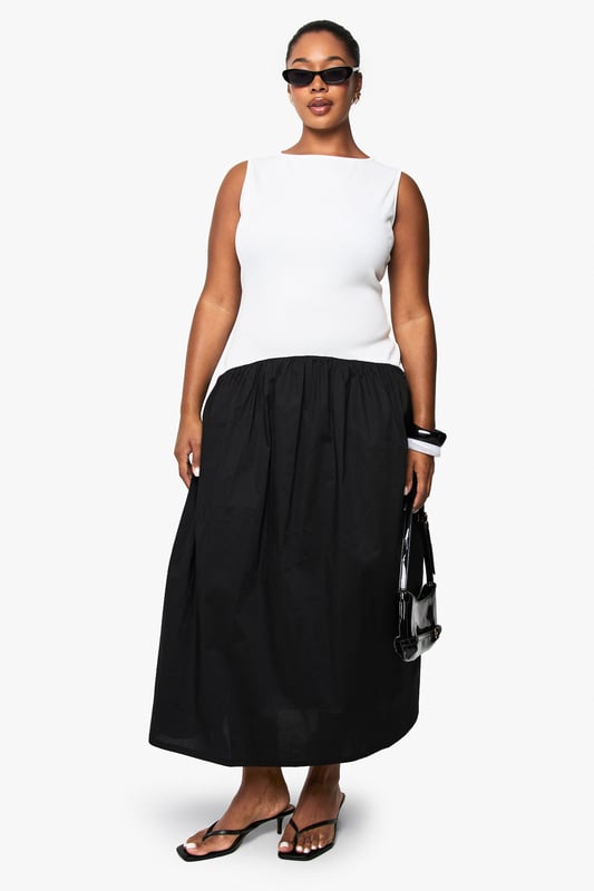 Striking contrast design with fitted sleeveless bodice and flowing midi skirt
        Elegant boat neckline offering a sophisticated silhouette
        Comfortable cotton fabric providing breathable wear throughout the day
        Versatile midi length perfect for various seasonal styling options
        Inclusive plus sizing designed to flatter and celebrate your curves
    
    This chic contrast midikleid combines contemporary style with effortless comfort. The structured white bodice creates a flattering foundation, whilst the flowing black skirt adds movement and drama to your silhouette. Style with minimalist flip flops and statement sunglasses for daytime casual events, or transform your look with block heels and bold accessories for family gatherings. The versatile design works brilliantly with a denim jacket for cooler evenings or a lightweight cardigan for spring outings. Add a structured handbag and chunky bracelet to complete the ensemble with modern flair. This Boohoo piece embodies the brand's commitment to inclusive fashion that doesn't compromise on trend-forward design - a wardrobe essential that transitions seamlessly from casual brunches to afternoon garden parties.