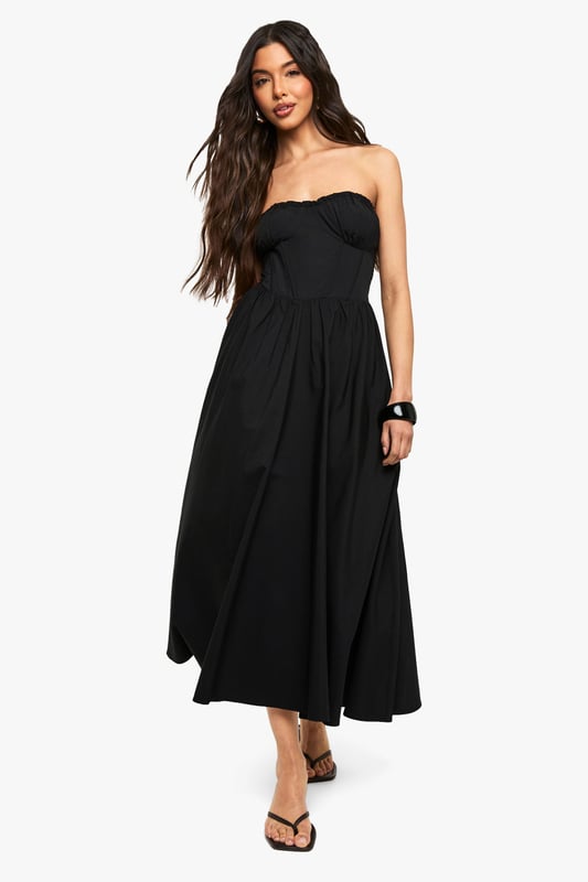 Bandeau Skater Midaxi Dress Elegant bandeau neckline with subtle ruching detail for a flattering silhouette
Fitted bodice transitions into a flowing skater skirt for effortless movement
Midaxi length offers versatile styling options for various occasions
Strapless design showcases shoulders and dcolletage beautifully
Structured woven fabric provides shape retention throughout wear
This bandeau skater midaxi dress from Boohoo combines casual comfort with chic styling. The strapless design creates a fresh summer look that can be dressed up or down depending on the occasion. For daytime outings, style as shown with minimal flat sandals and a compact shoulder bag for an effortlessly cool aesthetic. Add a denim jacket for cooler evenings or layer with a cropped cardigan for family gatherings. The versatile midaxi length works brilliantly for garden parties or casual brunches with friends. For a more polished look, pair with delicate jewellery and a sleek updo. The flowing skater silhouette flatters all body types while offering comfortable movement throughout the day. This wardrobe essential transitions seamlessly from casual daywear to evening drinks with a simple change of accessories.