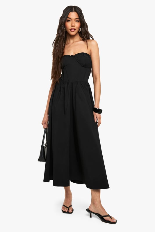 Bandeau Skater Midaxi Dress Elegant bandeau neckline with subtle ruching detail for a flattering silhouette
Fitted bodice transitions into a flowing skater skirt for effortless movement
Midaxi length offers versatile styling options for various occasions
Strapless design showcases shoulders and dcolletage beautifully
Structured woven fabric provides shape retention throughout wear
This bandeau skater midaxi dress from Boohoo combines casual comfort with chic styling. The strapless design creates a fresh summer look that can be dressed up or down depending on the occasion. For daytime outings, style as shown with minimal flat sandals and a compact shoulder bag for an effortlessly cool aesthetic. Add a denim jacket for cooler evenings or layer with a cropped cardigan for family gatherings. The versatile midaxi length works brilliantly for garden parties or casual brunches with friends. For a more polished look, pair with delicate jewellery and a sleek updo. The flowing skater silhouette flatters all body types while offering comfortable movement throughout the day. This wardrobe essential transitions seamlessly from casual daywear to evening drinks with a simple change of accessories.