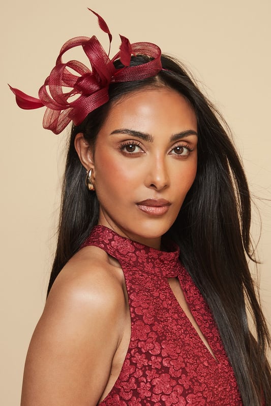 Loop And Feather Detail Headband Elegant headband featuring intricate loop detailing and delicate feather embellishments
Sculptural design creates a striking silhouette perfect for formal occasions
Lightweight construction ensures comfortable wear throughout the day
Secure fit with discreet attachment that keeps the headpiece perfectly positioned
Versatile accessory that complements both updos and flowing hairstyles
Add a touch of sophistication to your occasion ensemble with this exquisite loop and feather headband from Wallis. The artfully arranged loops create a dimensional effect that catches the light beautifully, while the feather accents add movement and drama. As shown, it pairs wonderfully with elegant wrap dresses for a coordinated look that's perfect for weddings, race days and formal garden parties. The headband sits comfortably at an angle, creating a flattering frame for your face without overwhelming your overall appearance. Style with sleek, polished hair for classic refinement, or contrast with loose waves for a more contemporary approach. This statement piece negates the need for elaborate jewellery - simply add delicate earrings to complete your glamorous occasion look.