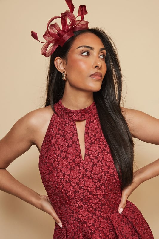 Loop And Feather Detail Headband Elegant headband featuring intricate loop detailing and delicate feather embellishments
Sculptural design creates a striking silhouette perfect for formal occasions
Lightweight construction ensures comfortable wear throughout the day
Secure fit with discreet attachment that keeps the headpiece perfectly positioned
Versatile accessory that complements both updos and flowing hairstyles
Add a touch of sophistication to your occasion ensemble with this exquisite loop and feather headband from Wallis. The artfully arranged loops create a dimensional effect that catches the light beautifully, while the feather accents add movement and drama. As shown, it pairs wonderfully with elegant wrap dresses for a coordinated look that's perfect for weddings, race days and formal garden parties. The headband sits comfortably at an angle, creating a flattering frame for your face without overwhelming your overall appearance. Style with sleek, polished hair for classic refinement, or contrast with loose waves for a more contemporary approach. This statement piece negates the need for elaborate jewellery - simply add delicate earrings to complete your glamorous occasion look.