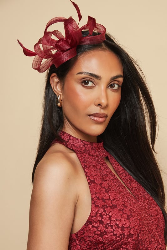 Loop And Feather Detail Headband Elegant headband featuring intricate loop detailing and delicate feather embellishments
Sculptural design creates a striking silhouette perfect for formal occasions
Lightweight construction ensures comfortable wear throughout the day
Secure fit with discreet attachment that keeps the headpiece perfectly positioned
Versatile accessory that complements both updos and flowing hairstyles
Add a touch of sophistication to your occasion ensemble with this exquisite loop and feather headband from Wallis. The artfully arranged loops create a dimensional effect that catches the light beautifully, while the feather accents add movement and drama. As shown, it pairs wonderfully with elegant wrap dresses for a coordinated look that's perfect for weddings, race days and formal garden parties. The headband sits comfortably at an angle, creating a flattering frame for your face without overwhelming your overall appearance. Style with sleek, polished hair for classic refinement, or contrast with loose waves for a more contemporary approach. This statement piece negates the need for elaborate jewellery - simply add delicate earrings to complete your glamorous occasion look.