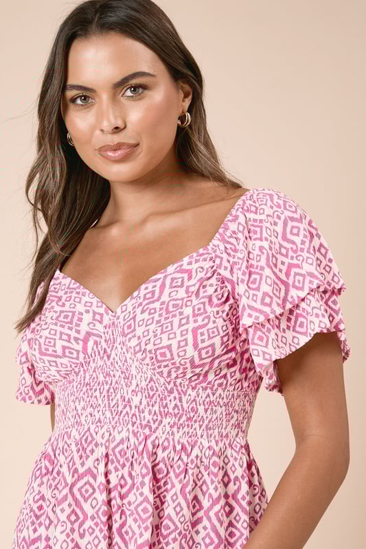 Striking geo print pattern throughout for a distinctive look
        Feminine shirred bodice that flatters your figure
        Delicate frill detail on the short flutter sleeves
        Elegant sweetheart neckline that frames the dcolletage
        Tiered design creates a flowing silhouette with added movement
    
    This charming Dorothy Perkins top combines comfort with style through its beautifully shirred bodice and playful geo print. The feminine flutter sleeves with frill detailing add a touch of romance, while the tiered design creates a flattering shape that works wonderfully for daytime occasions. Style with your favourite skinny jeans and trainers for weekend brunches with friends, or pair with cropped trousers and sandals for family gatherings. The versatile design makes it perfect for baby showers when matched with a denim skirt and delicate jewellery. The lightweight viscose fabric ensures all-day comfort while the shirred detailing accentuates your waist beautifully. This top effortlessly transitions from casual coffee dates to afternoon garden parties with just a simple change of accessories.